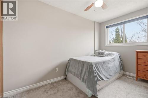The bedroom features carpeted flooring, a window providing natural light, and a ceiling fan - 2349 Middlesmoor Crescent, Burlington, ON - Indoor Photo Showing Bedroom