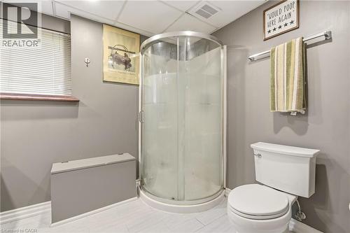 This bathroom features a clear glass corner shower, a toilet, and light-colored flooring - 2349 Middlesmoor Crescent, Burlington, ON - Indoor Photo Showing Bathroom