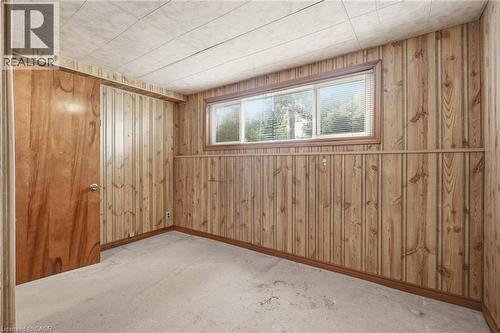 This room features wood paneling, a drop ceiling, and carpeted flooring - 2349 Middlesmoor Crescent, Burlington, ON - Indoor Photo Showing Other Room