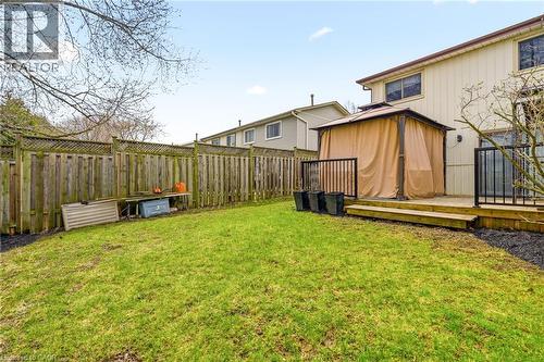 The property features an extensive fenced backyard with a well-maintained lawn and a wooden deck - 2349 Middlesmoor Crescent, Burlington, ON - Outdoor