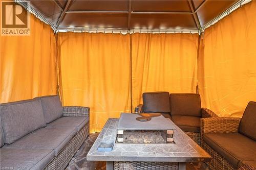 The property features a gazebo with yellow privacy curtains, providing an inviting outdoor living space - 2349 Middlesmoor Crescent, Burlington, ON - Indoor