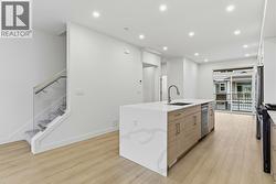 Kitchen & Stairs to Upper Level. Photo is of a similar home in the community - 