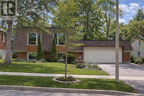 The property features a brick exterior with a sloped roof and a two-car garage - 42 Culpepper Drive, Waterloo, ON - Outdoor