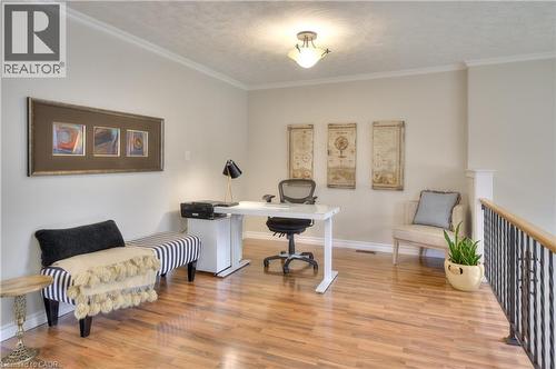 This versatile interior space features hardwood flooring, light-colored walls, and crown molding - 42 Culpepper Drive, Waterloo, ON - Indoor Photo Showing Office