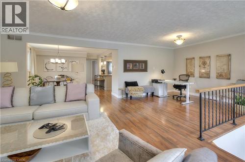 Spacious living area featuring hardwood flooring, crown molding, and recessed lighting - 42 Culpepper Drive, Waterloo, ON - Indoor Photo Showing Living Room