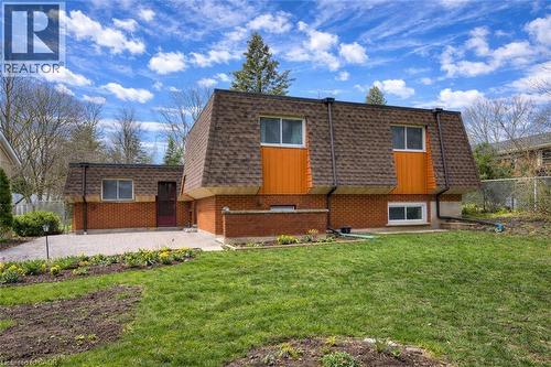 The property features a brick exterior with an asphalt shingle roof - 42 Culpepper Drive, Waterloo, ON - Outdoor