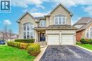 This property features a brick exterior, an integrated two-car garage, and a paved driveway - 4267 Sarazen Drive, Burlington, ON  - Outdoor With Facade 