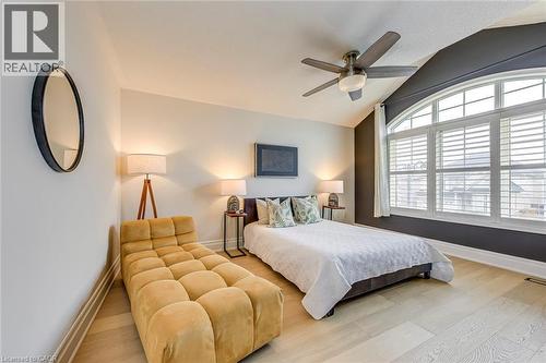 Room featuring light-colored flooring, a large arched window with white blinds, and a ceiling fan - 4267 Sarazen Drive, Burlington, ON - Indoor Photo Showing Bedroom