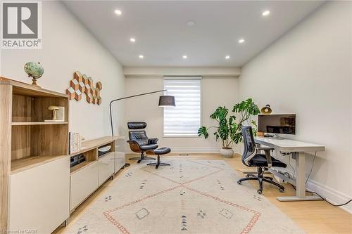 This versatile room features light hardwood floors, recessed lighting, and a window with blinds - 4267 Sarazen Drive, Burlington, ON - Indoor Photo Showing Office