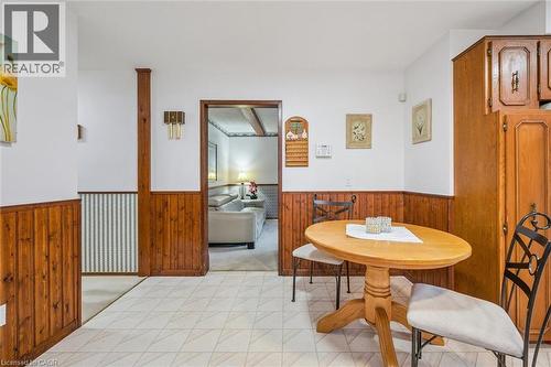 The property features wood paneling and wainscoting, complemented by light-toned patterned floor tiles - 217 Johanna Drive, Cambridge, ON - Indoor Photo Showing Dining Room
