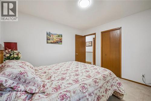This room features white walls, a ceiling-mounted light fixture, and wooden doors - 217 Johanna Drive, Cambridge, ON - Indoor Photo Showing Bedroom