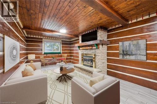 The living area features wood paneled walls, a wood plank ceiling with exposed beams, and a brick fireplace - 217 Johanna Drive, Cambridge, ON - Indoor With Fireplace
