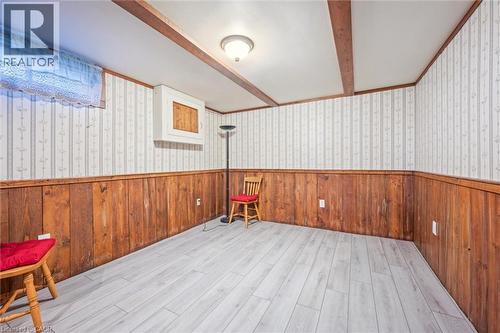 This versatile room features light-colored flooring, wood paneling, and a wallpapered upper wall - 217 Johanna Drive, Cambridge, ON - Indoor Photo Showing Other Room