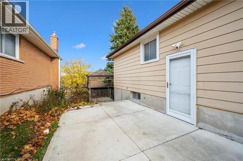 The property features exterior siding, a secure entry door, and a paved patio area - 217 Johanna Drive, Cambridge, ON - Outdoor With Exterior