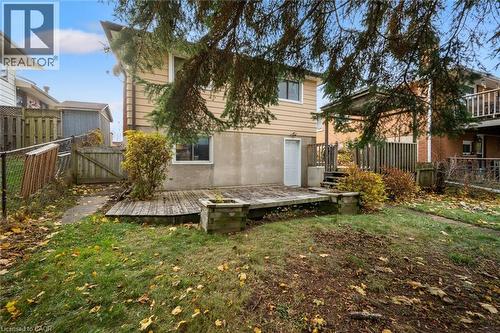 The property features a backyard with a wooden deck and a grassy area - 217 Johanna Drive, Cambridge, ON - Outdoor