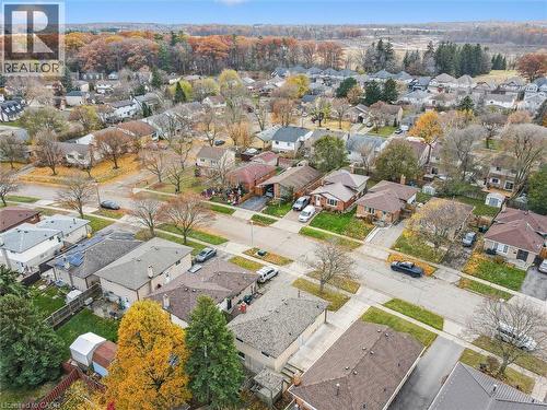 This aerial view showcases the property within a well-established neighborhood, featuring a mix of residential homes with varied rooflines and surrounding trees displaying autumnal colors - 217 Johanna Drive, Cambridge, ON - Outdoor With View