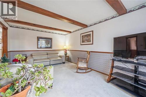 Living area featuring exposed wood beams, white walls, and light-colored carpeting - 217 Johanna Drive, Cambridge, ON - Indoor Photo Showing Other Room