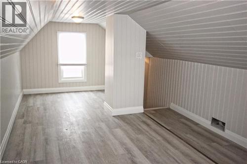 This room features sloped, paneled ceilings, paneled walls, and a window providing natural illumination - 1356 Upper Wellington Street, Hamilton, ON - Indoor Photo Showing Other Room