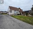 The property features a brown roof and light-colored siding with dark trim, set on a lot with a paved driveway and a lawn - 1356 Upper Wellington Street, Hamilton, ON  - Outdoor 
