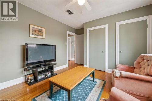 Living area featuring hardwood floors, light green walls, white trim, and a ceiling fan - 155 Hungerford Road, Cambridge, ON - Indoor Photo Showing Living Room