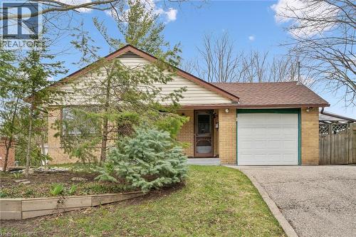 The property features a brick exterior with an attached garage and a driveway - 155 Hungerford Road, Cambridge, ON - Outdoor