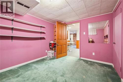 This room features pink walls, green carpet, and a white ceiling with recessed lighting - 155 Hungerford Road, Cambridge, ON - Indoor Photo Showing Other Room