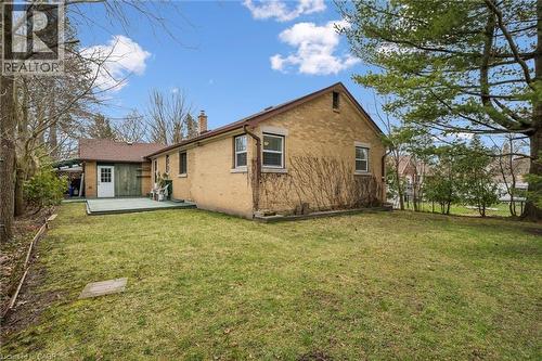 The property features a spacious lawn, a rear deck, and mature trees providing shade - 155 Hungerford Road, Cambridge, ON - Outdoor