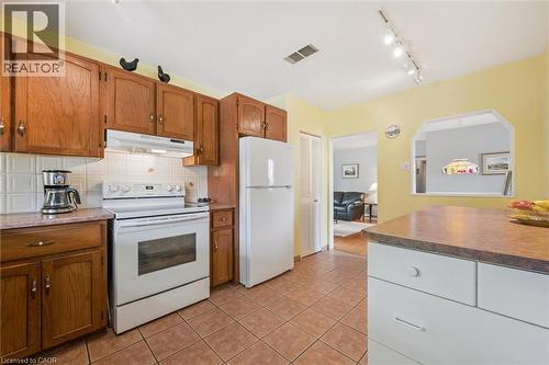 The kitchen features wood cabinetry, a white electric range, and a white refrigerator - 155 Hungerford Road, Cambridge, ON - Indoor Photo Showing Kitchen