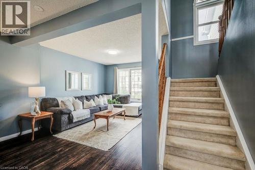 Stairway featuring wood finished floors and a textured ceiling - 633 Grange Crescent, Waterloo, ON - Indoor