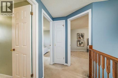 Hallway featuring a textured ceiling and light colored carpet - 633 Grange Crescent, Waterloo, ON - Indoor Photo Showing Other Room