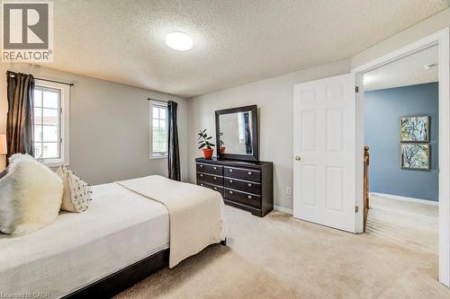 Bedroom featuring a textured ceiling and carpet floors - 633 Grange Crescent, Waterloo, ON - Indoor Photo Showing Bedroom