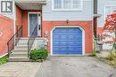 Entrance to property with a garage, brick siding, and driveway - 633 Grange Crescent, Waterloo, ON  - Outdoor With Exterior 