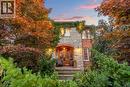 The property features a stone and brick exterior, with mature trees and extensive landscaping surrounding the entrance - 4278 Clubview Drive, Burlington, ON  - Outdoor With Deck Patio Veranda 