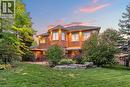 The property features a brick exterior with multiple windows and exterior lighting - 4278 Clubview Drive, Burlington, ON  - Outdoor 