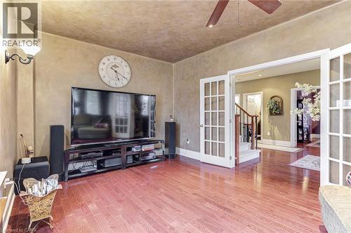 Living area featuring hardwood floors, a ceiling fan, and double french doors - 4278 Clubview Drive, Burlington, ON - Indoor Photo Showing Other Room