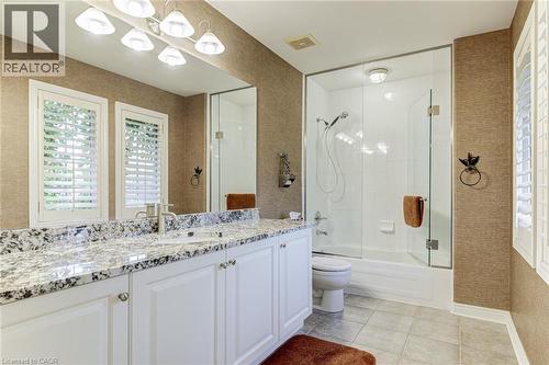 Bathroom featuring a dual vanity with a granite countertop and white cabinetry - 4278 Clubview Drive, Burlington, ON - Indoor Photo Showing Bathroom