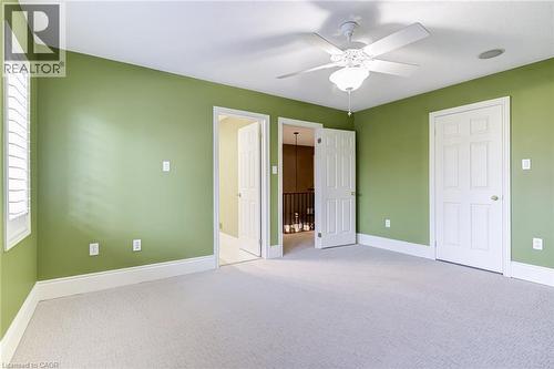 This room features carpeted flooring, a ceiling fan, and window shutters - 4278 Clubview Drive, Burlington, ON - Indoor