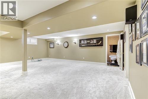 Expansive carpeted area with recessed lighting, an accessible lavatory, and a window with blinds - 4278 Clubview Drive, Burlington, ON - Indoor