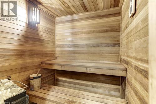 This property features a sauna with wooden paneling on the walls and ceiling, including built-in wooden benches for seating - 4278 Clubview Drive, Burlington, ON - Indoor Photo Showing Other Room