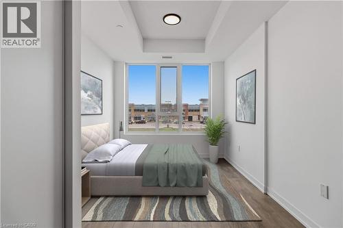 This bedroom offers large windows providing natural light, light wood flooring, and a contemporary ceiling light fixture - 4878 Powers Common Unit# 224, Burlington, ON - Indoor Photo Showing Other Room