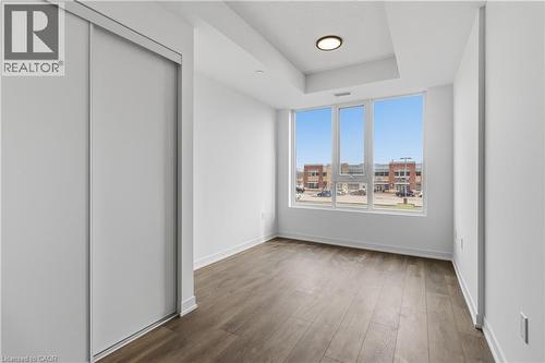 This room features large windows providing ample natural light and views of the surrounding buildings - 4878 Powers Common Unit# 224, Burlington, ON - Indoor Photo Showing Other Room