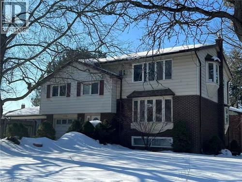 The property features a brick and siding exterior, bay windows on the front facade, and an attached garage - 134 Greenbrier Drive, Waterloo, ON 
