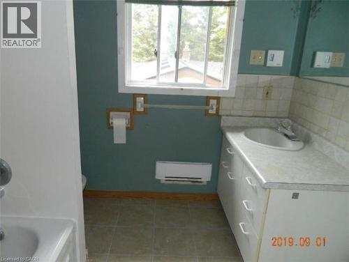 Bathroom featuring a vanity with an integrated sink, a window, and tiled flooring - 134 Greenbrier Drive, Waterloo, ON 