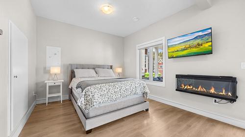 371-6727 Marbella Loop, Kelowna, BC - Indoor Photo Showing Bedroom With Fireplace
