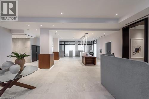 Spacious interior with light-colored flooring, recessed lighting, and a modern desk area - 385 Winston Road Unit# 1607, Grimsby, ON - Indoor Photo Showing Other Room