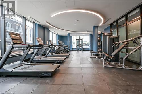 The property features a well-equipped fitness center with various exercise machines, including treadmills and weight equipment - 385 Winston Road Unit# 1607, Grimsby, ON - Indoor Photo Showing Gym Room
