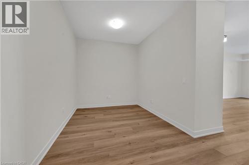 Den area, 9 ft ceilings, vinyl plank flooring - 385 Winston Road Unit# 1607, Grimsby, ON - Indoor Photo Showing Other Room
