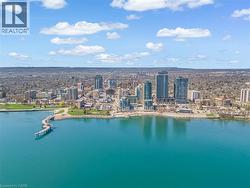 Aerial view showcasing the waterfront, nearby park areas, and a pier extending into the water - 