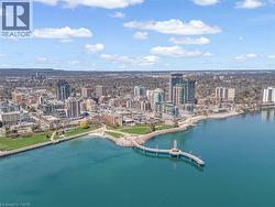 An aerial view showcases the vibrant waterfront community, featuring high-rise buildings and green spaces along the shoreline - 