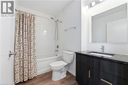 Bathroom featuring a dark wood vanity with a granite countertop and an undermount sink - 104 Garment Street Unit# 1206, Kitchener, ON - Indoor Photo Showing Bathroom